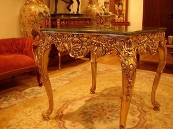 CARVED GILT GAMES TABLE WITH GREEN MARBLE MOUNTED TOP.